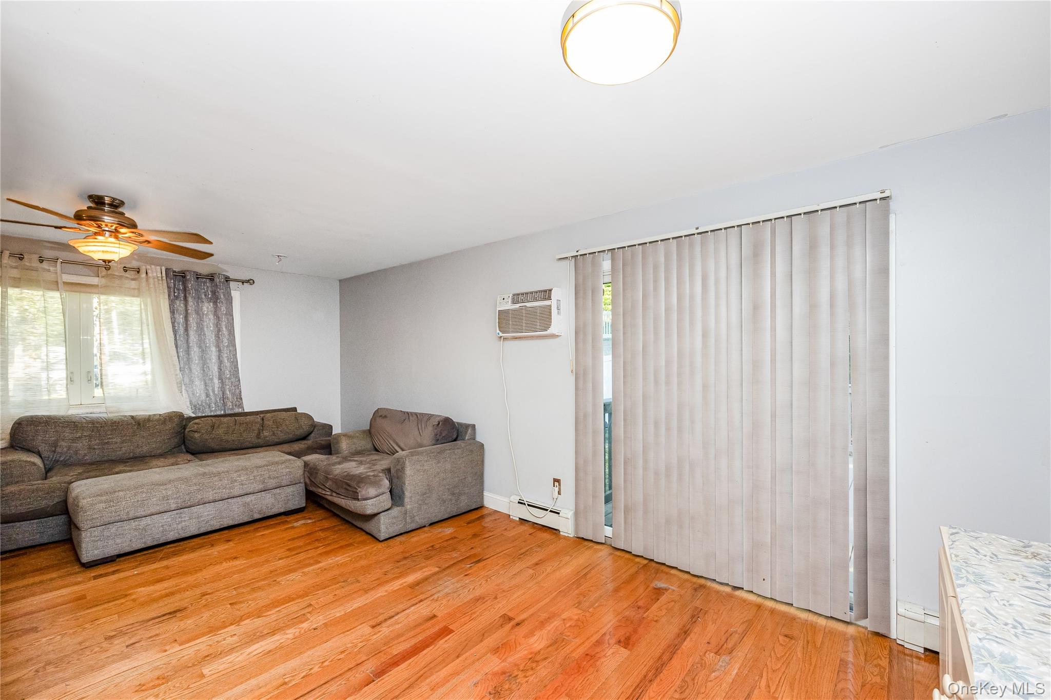 16 Hillside Road Farmingville, NY 11738 - Photo 10 of 22 a living room with furniture and a window