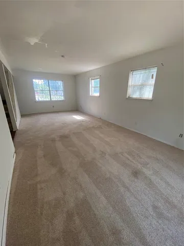 a view of a big room with windows