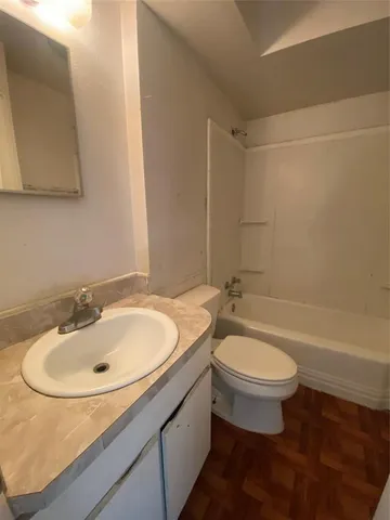 a bathroom with a sink a toilet and bathtub