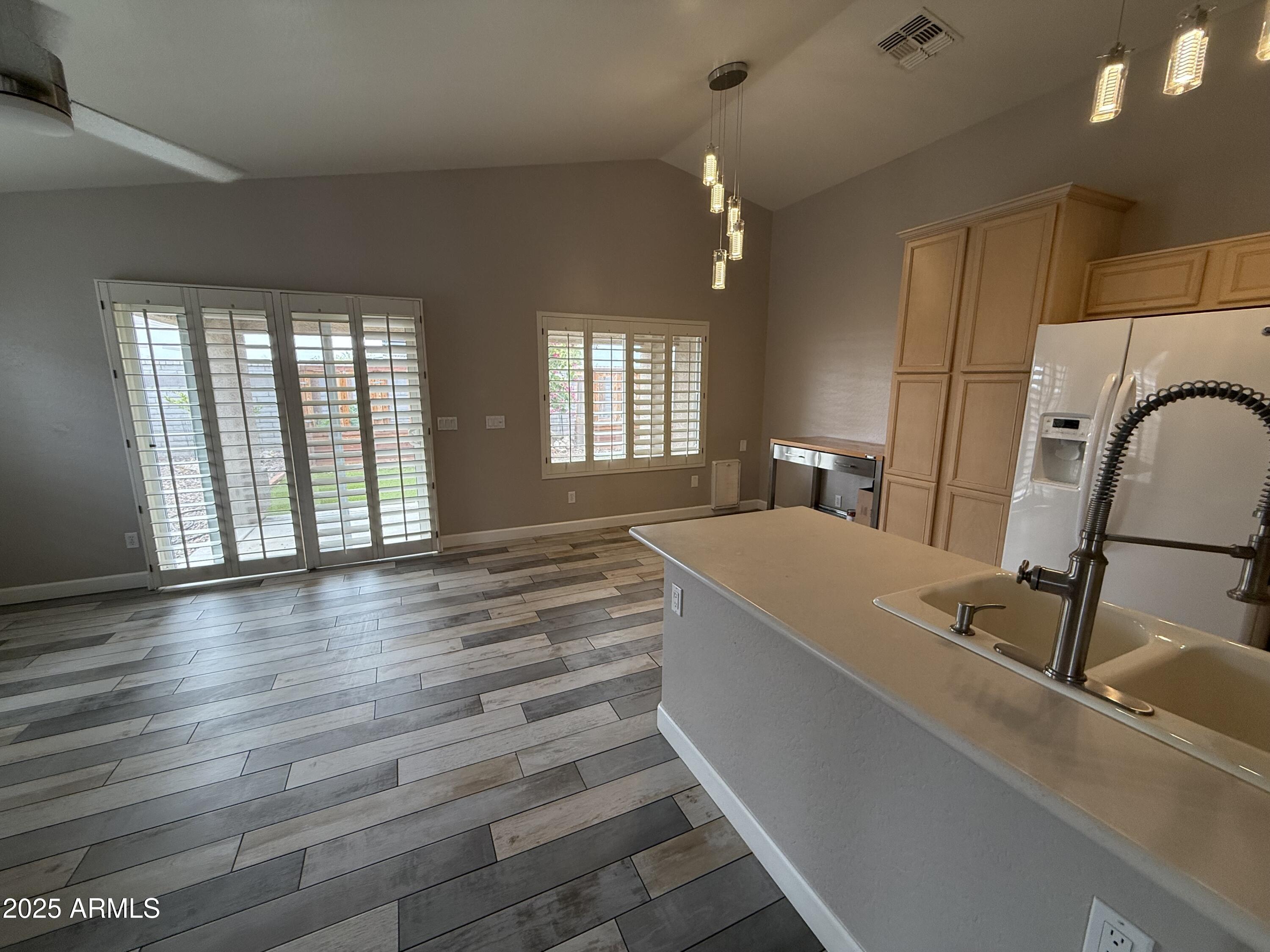 1736 North Seton Mesa, AZ 85205 - Photo 11 of 26 a view of a kitchen with kitchen island a sink wooden floor and a large window