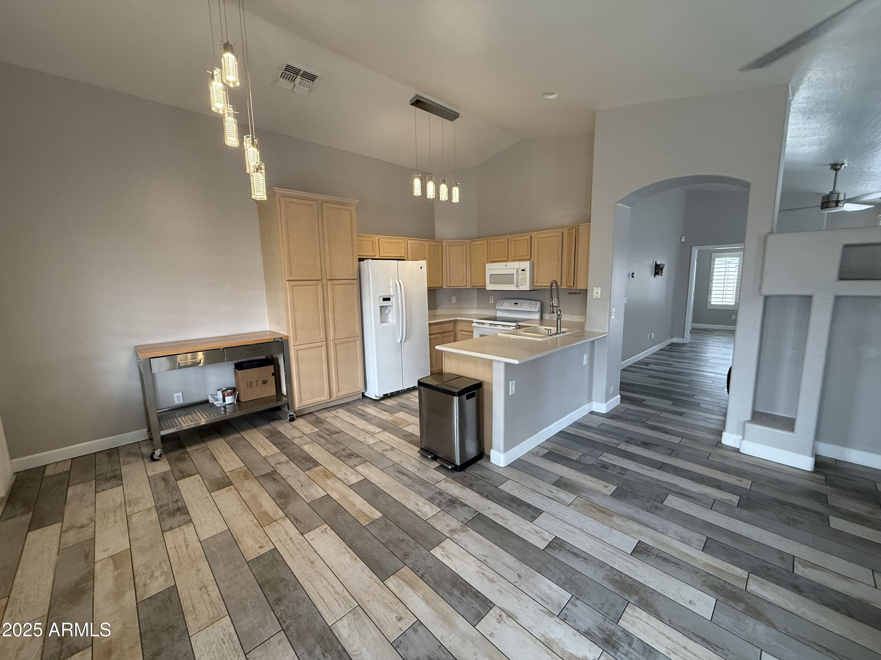 1736 North Seton Mesa, AZ 85205 - Photo 12 of 26 a kitchen with stainless steel appliances a stove top oven and cabinets