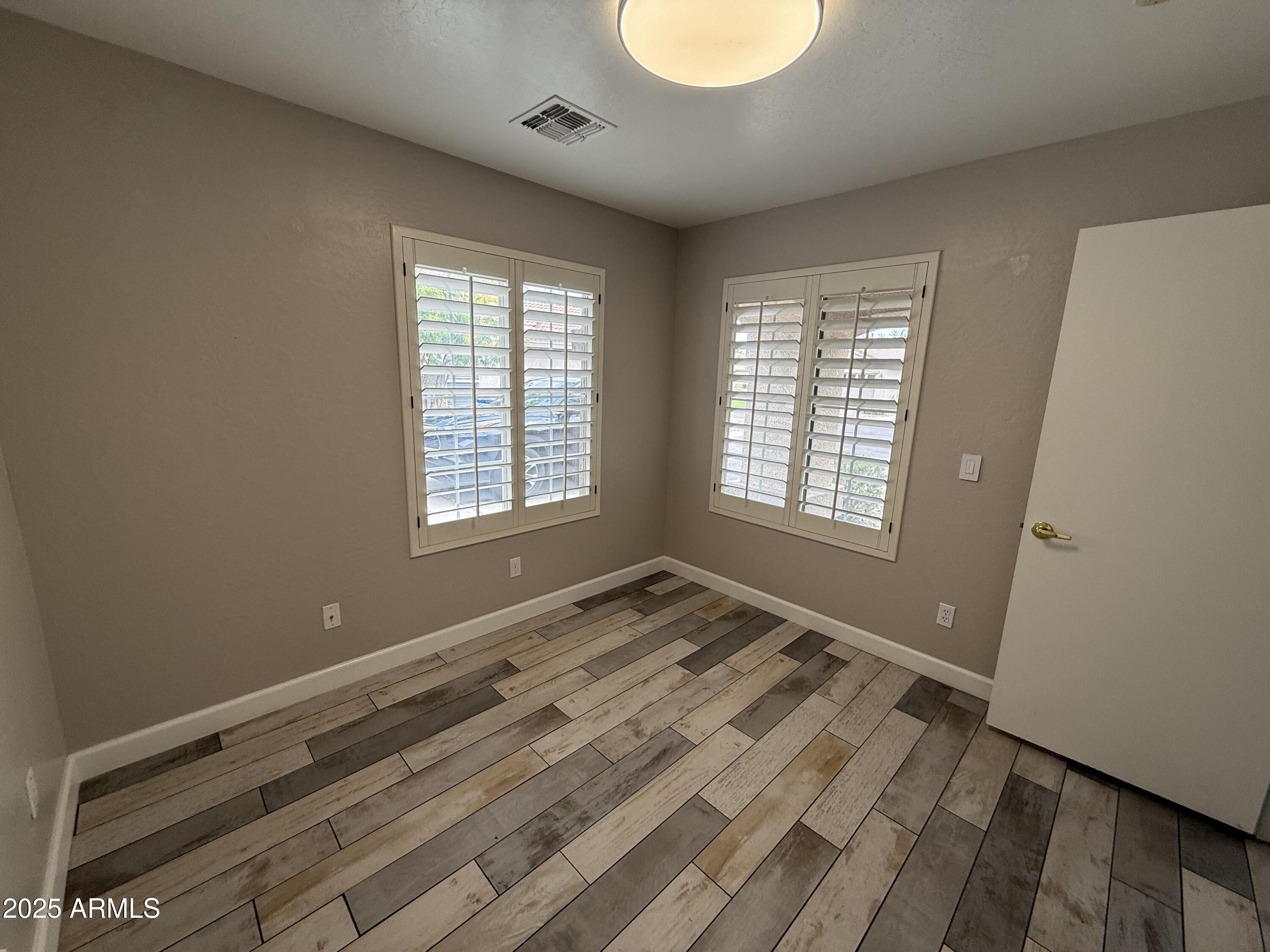 1736 North Seton Mesa, AZ 85205 - Photo 20 of 26 a view of empty room with wooden floor and fan