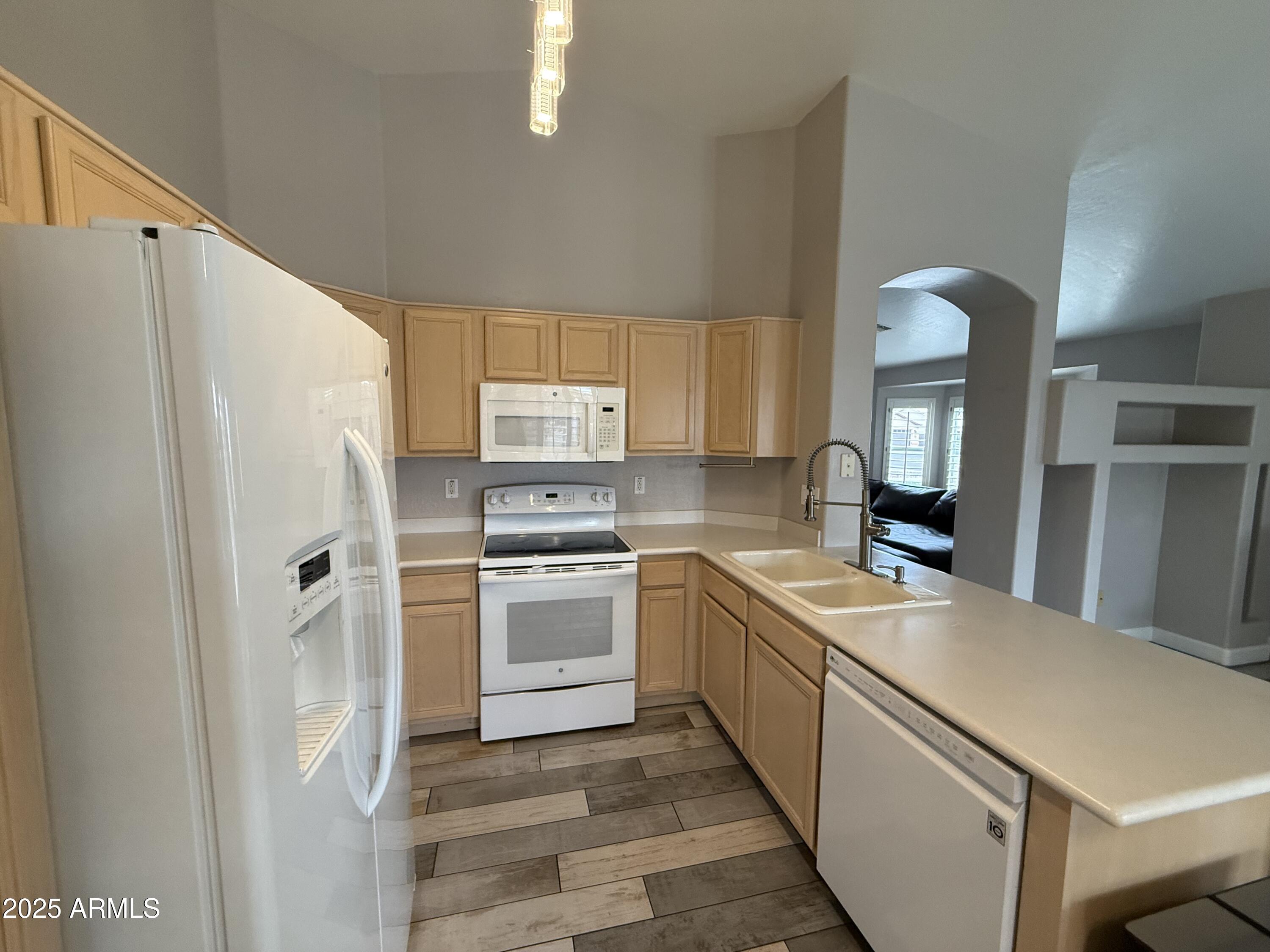 1736 North Seton Mesa, AZ 85205 - Photo 10 of 26 a kitchen with a sink a refrigerator and a stove