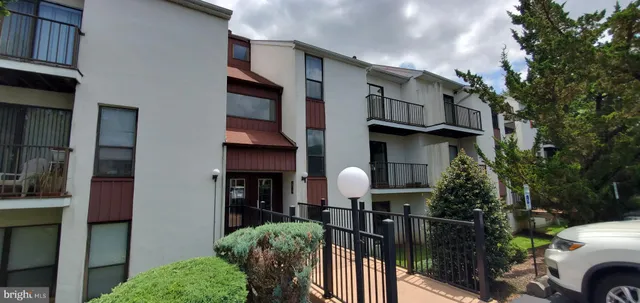 a view of a house and car parked front of main door