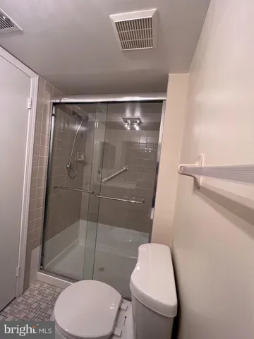 a bathroom with a toilet and a shower
