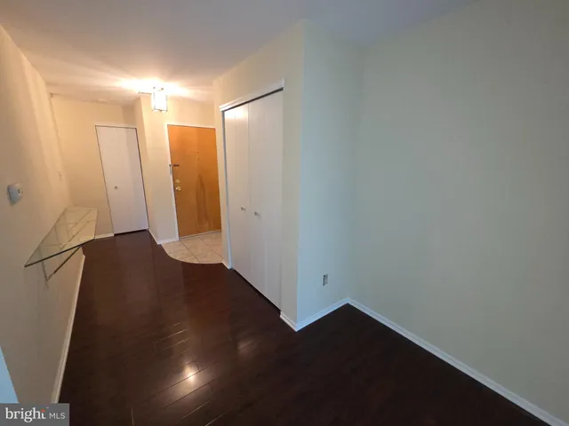 a view of hallway with wooden floor