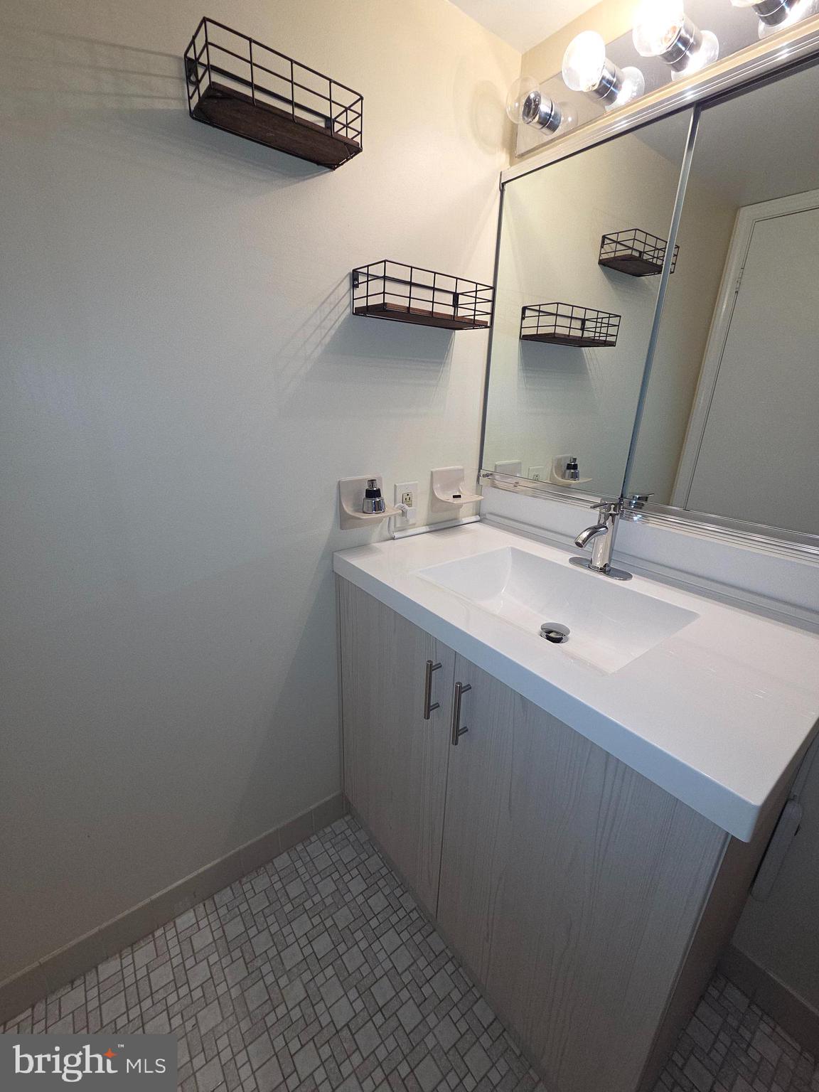 301 Byberry Road, Unit E8 Philadelphia, PA 19116 - Photo 40 of 44 a bathroom with a sink and mirror