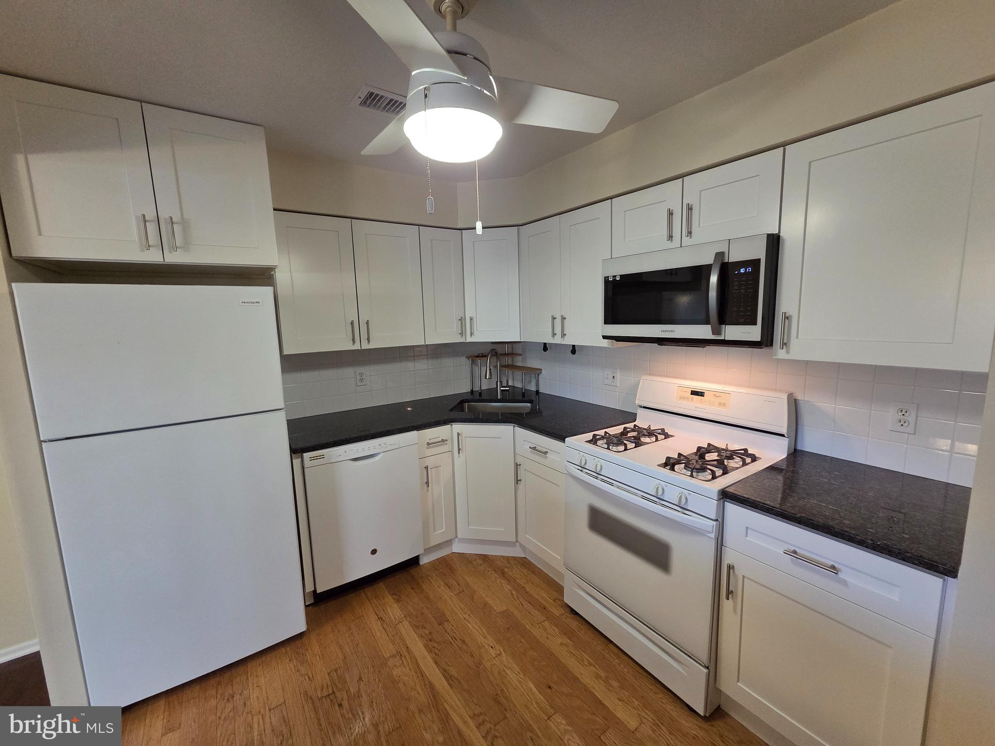 301 Byberry Road, Unit E8 Philadelphia, PA 19116 - Photo 43 of 44 a kitchen with a refrigerator stove and microwave