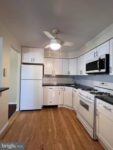 a kitchen with a white cabinets and white appliances