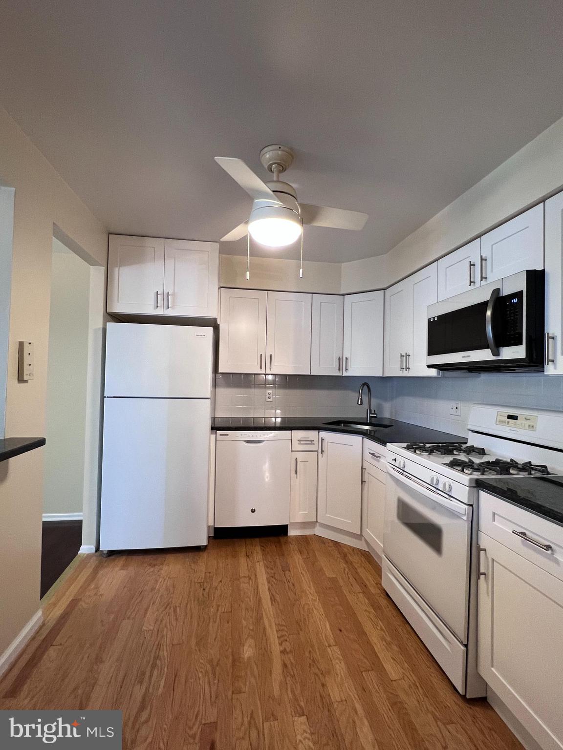 301 Byberry Road, Unit E8 Philadelphia, PA 19116 - Photo 5 of 44 a kitchen with a white cabinets and white appliances
