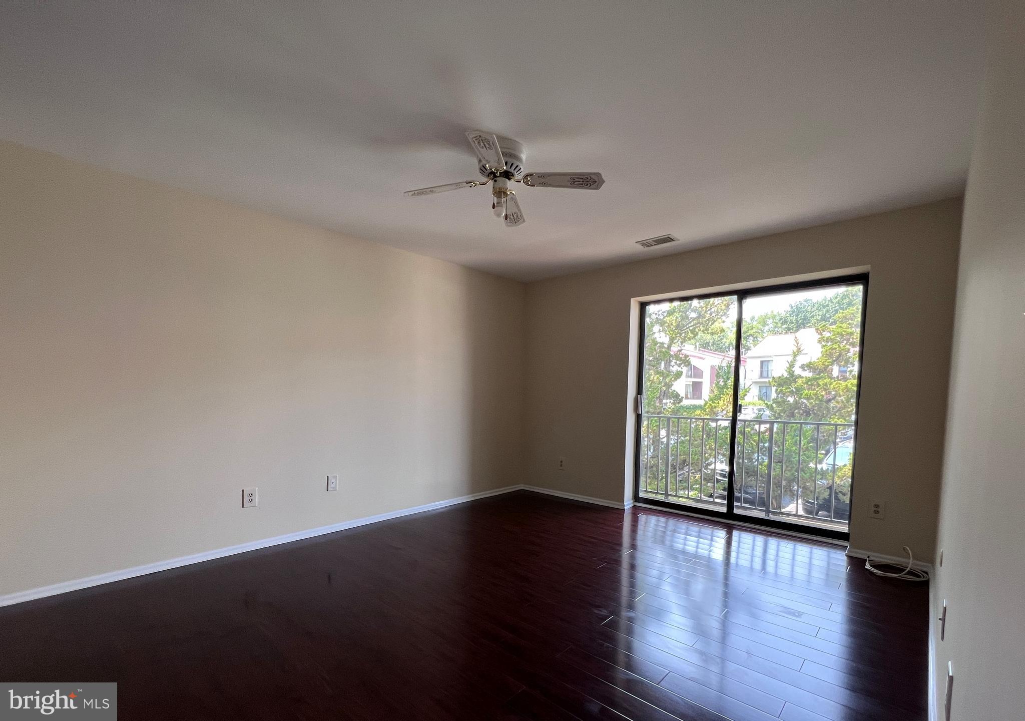 301 Byberry Road, Unit E8 Philadelphia, PA 19116 - Photo 6 of 44 an empty room with wooden floor and windows