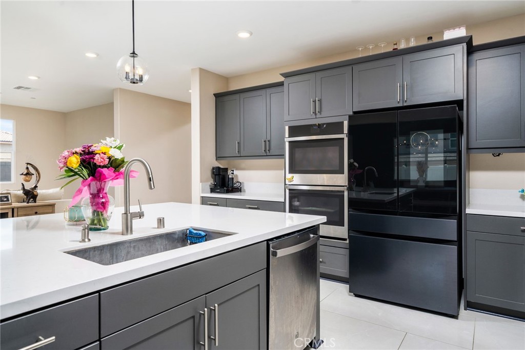 2414 Crater Avenue Rialto, CA 92377 - Photo 11 of 50 a kitchen with a sink refrigerator and microwave