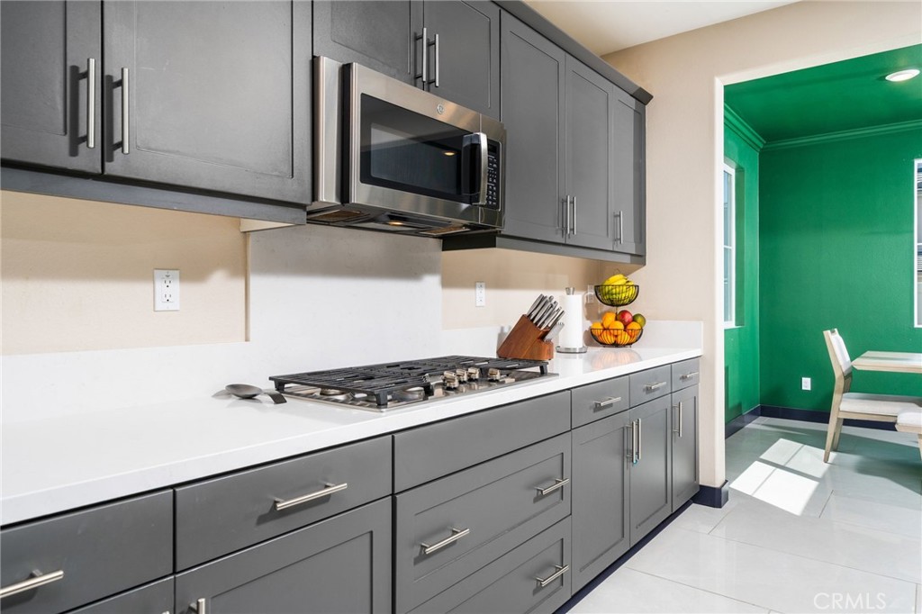 2414 Crater Avenue Rialto, CA 92377 - Photo 12 of 50 a kitchen with stainless steel appliances a cabinets and a stove top oven