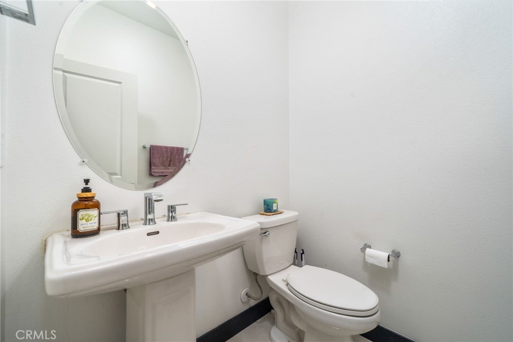 2414 Crater Avenue Rialto, CA 92377 - Photo 15 of 50 a bathroom with a sink mirror and toilet
