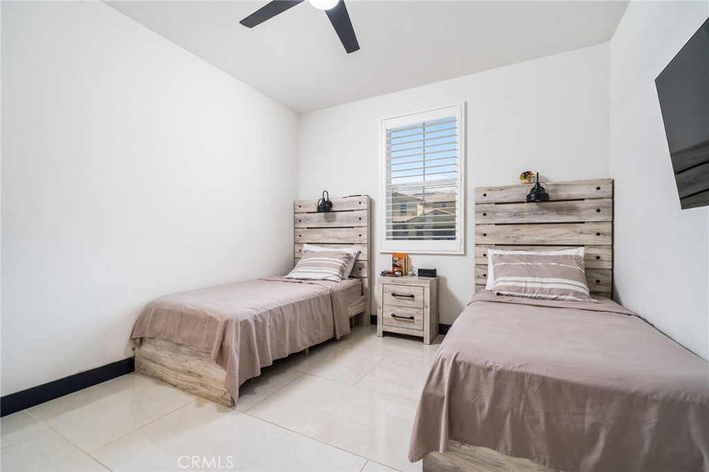 2414 Crater Avenue Rialto, CA 92377 - Photo 16 of 50 a bedroom with a bed and a flat tv screen