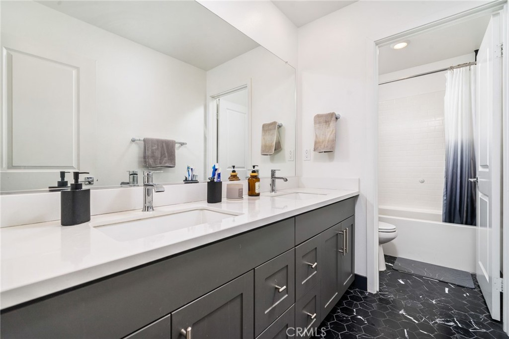 2414 Crater Avenue Rialto, CA 92377 - Photo 21 of 50 a bathroom with a double vanity sink and mirror