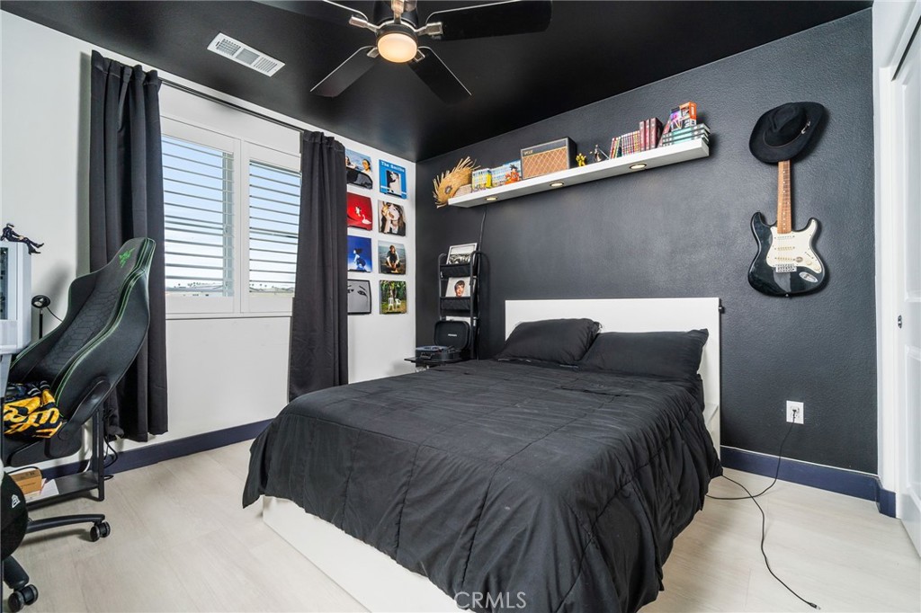 2414 Crater Avenue Rialto, CA 92377 - Photo 24 of 50 a bedroom with a bed and ceiling fan