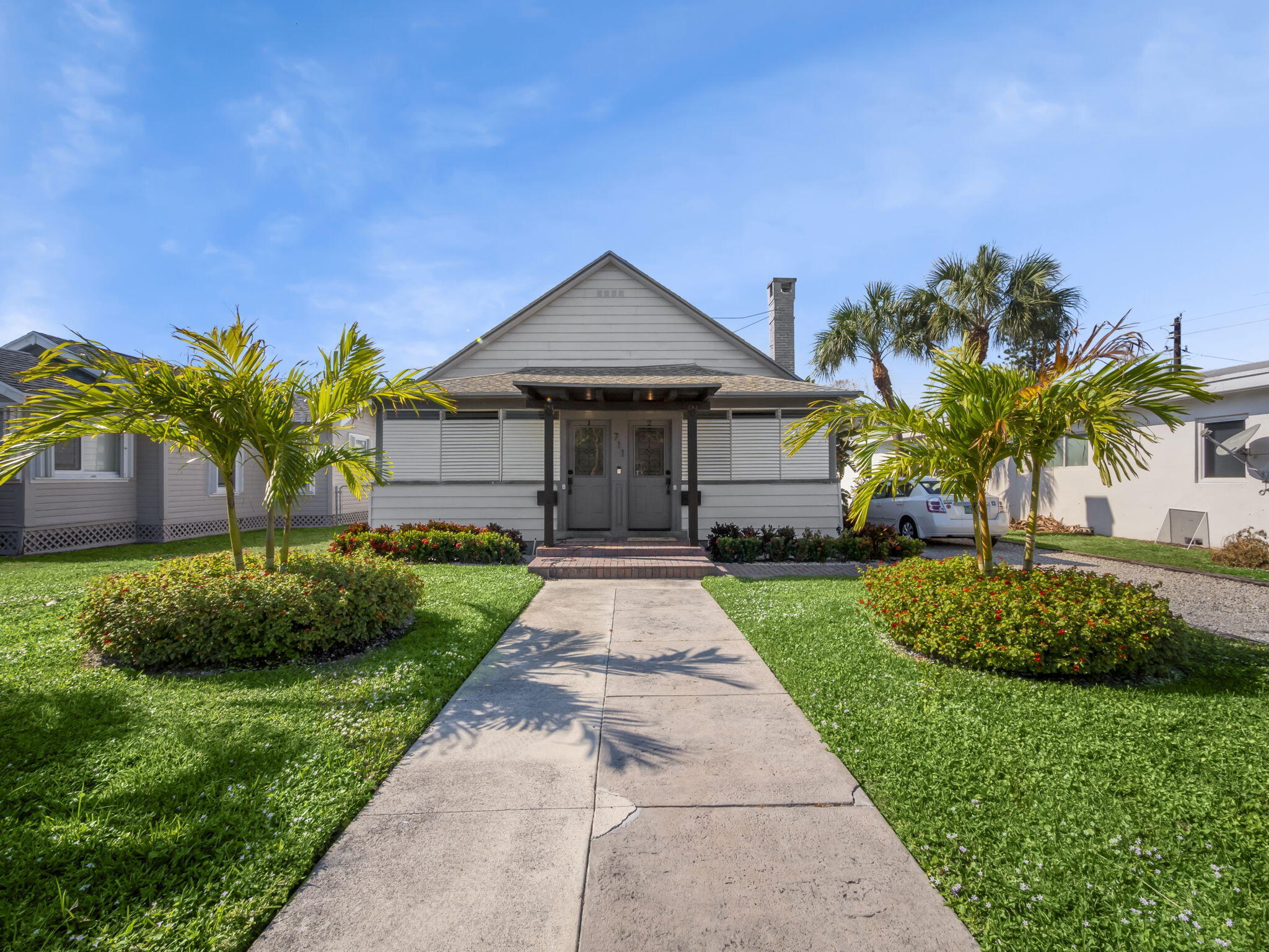 711 South N Street, Unit 1 Lake Worth Beach, FL 33460 - Photo 11 of 12 a front view of a house with a garden