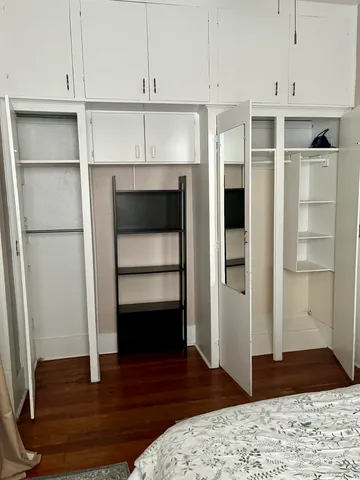 a room with a bed and cabinets