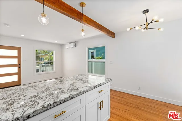 a view of wooden floor and chandelier in a room
