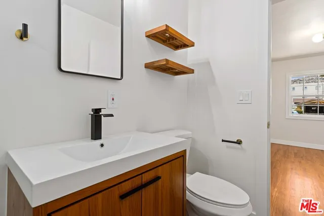 a bathroom with a sink a toilet and mirror