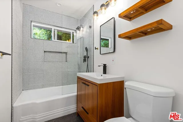 a bathroom with a sink a toilet and bathtub