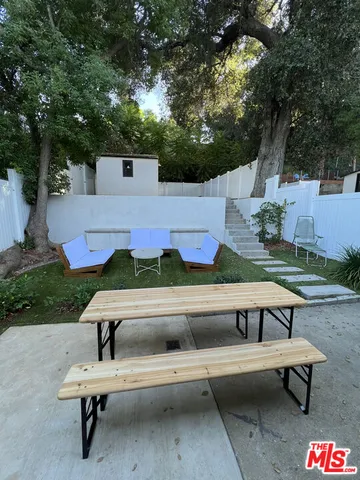 a view of a patio with a table and chairs