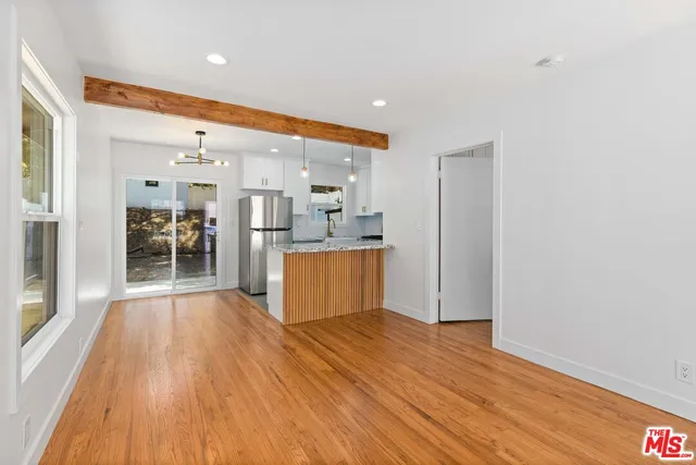 a view of a kitchen with cabinets and wooden floor