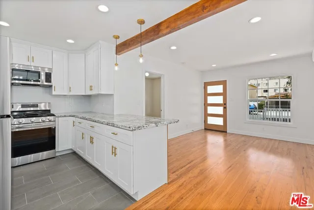 a kitchen with stainless steel appliances granite countertop a stove and a sink