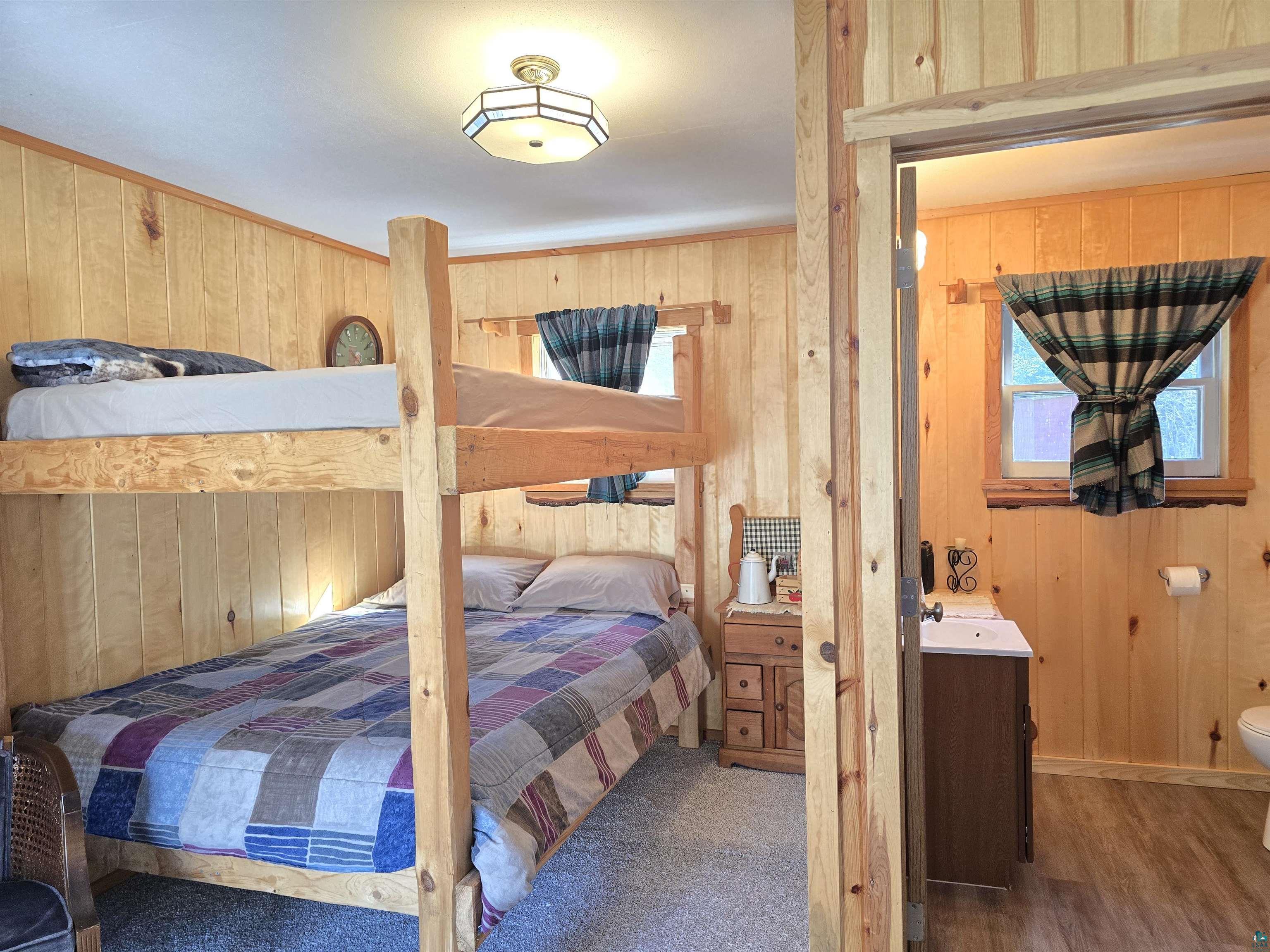 88910 Bark Point Road Herbster, WI 54844 - Photo 26 of 31 Bedroom with wood walls and wood finished floors