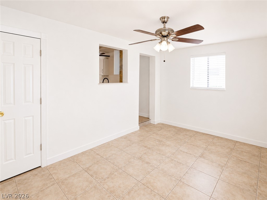 2870 South Sandhill Road Las Vegas, NV 89121 - Photo 17 of 64 A living space offers a pass-through window to the kitchen and an inviting ceiling fan for comfort.