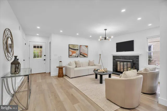 a living room with fireplace furniture and a flat screen tv
