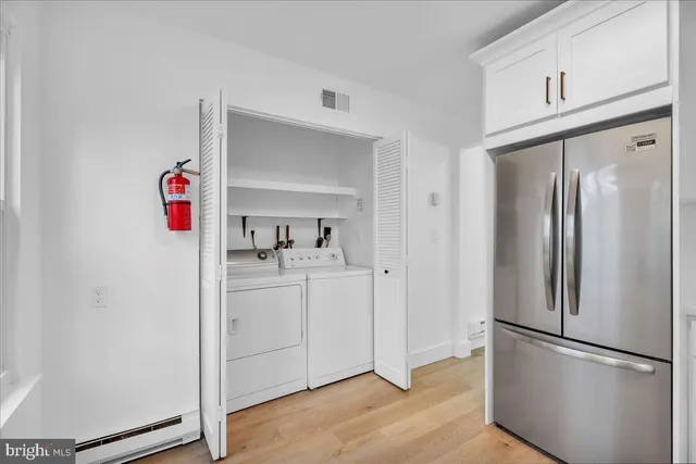 a utility room with cabinets washer and dryer