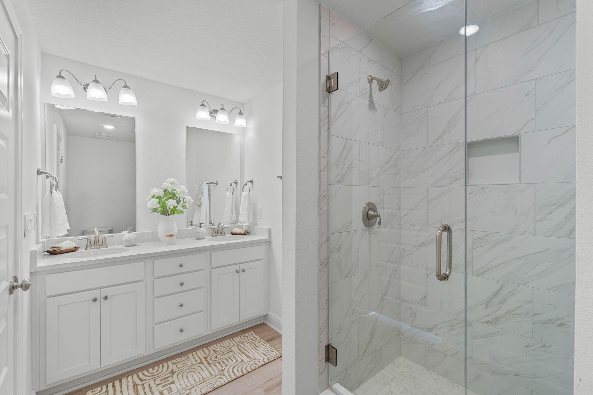 1 Renea Cove Destin, FL 32541 - Photo 38 of 51 a bathroom with a double vanity sink a large mirror and shower