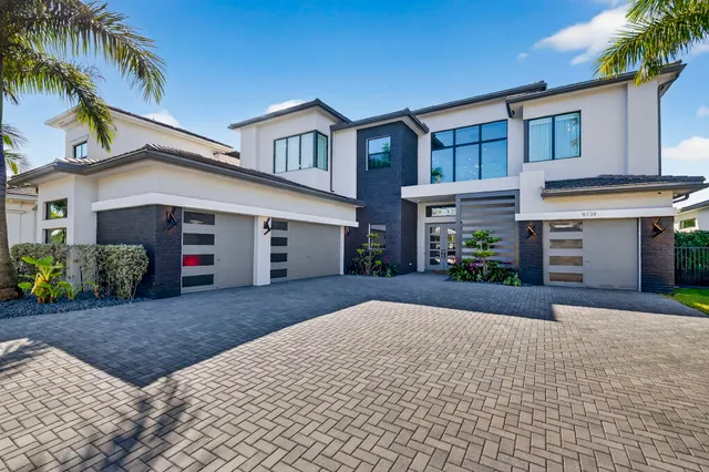 a front view of a house with a yard and a garage