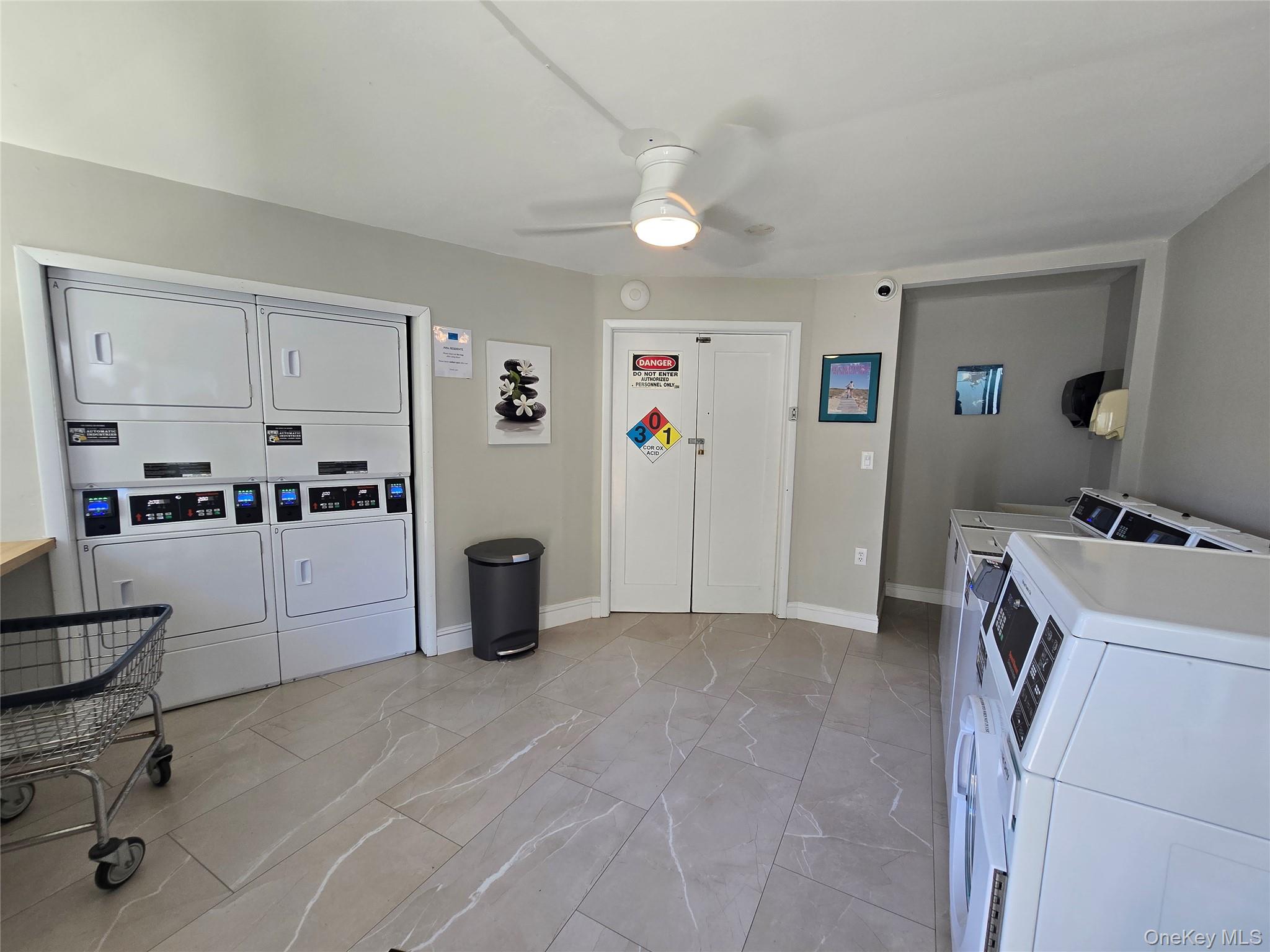 585 Dune Road, Unit L10 Westhampton, NY 11978 - Photo 18 of 25 Dedicated laundry facility featuring multiple commercial-grade washer and dryer units