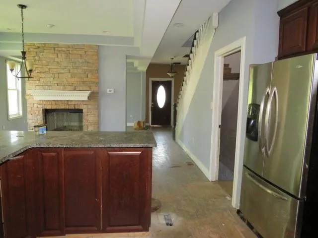 a kitchen with stainless steel appliances granite countertop a refrigerator and a sink