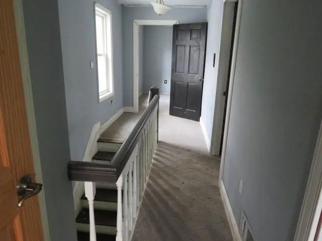 a view of entryway and hall with a chair