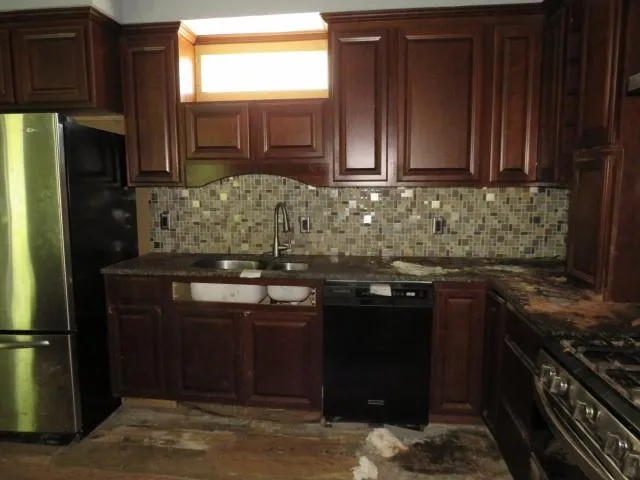 a kitchen with granite countertop stainless steel appliances and wooden cabinets