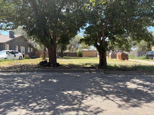 a view of a yard with swimming pool