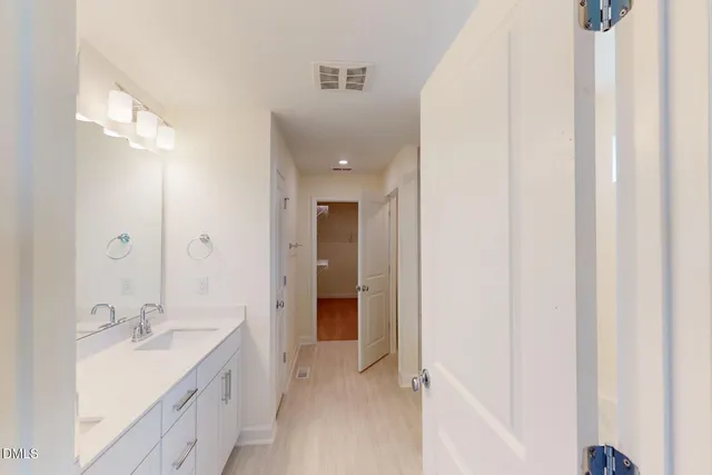 a bathroom with a double vanity sink and mirror