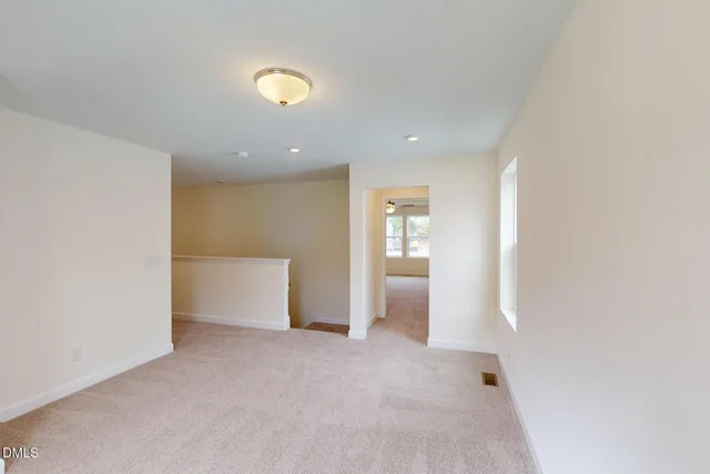 an empty room with windows and entrance