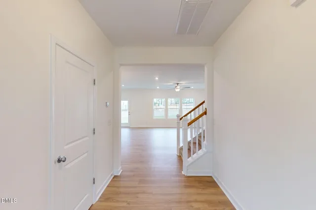 a view of a hallway view with wooden floor and staircase