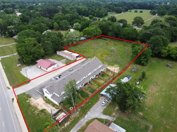 an aerial view of a house with outdoor space and lake view
