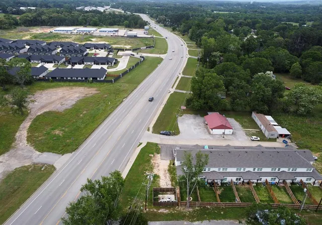 an aerial view of a house with a yard