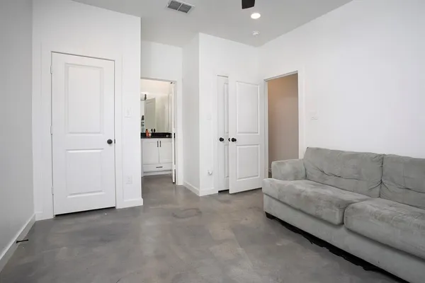 a view of washer and dryer with bathroom in the background