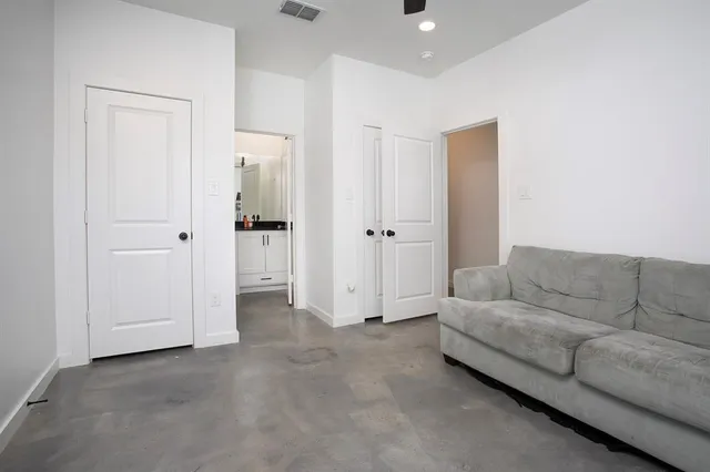 a view of washer and dryer with bathroom in the background