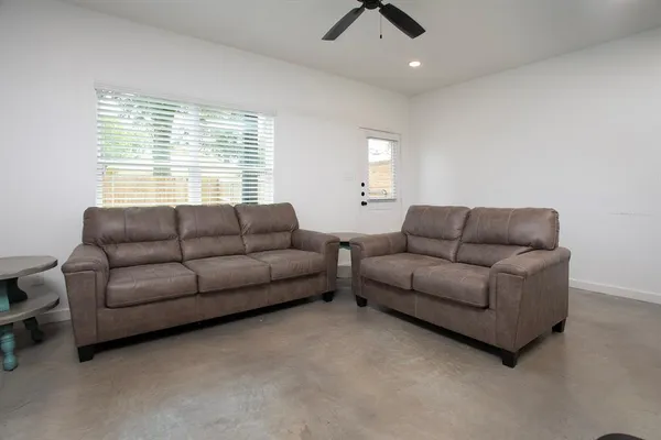 a living room with furniture and a chair