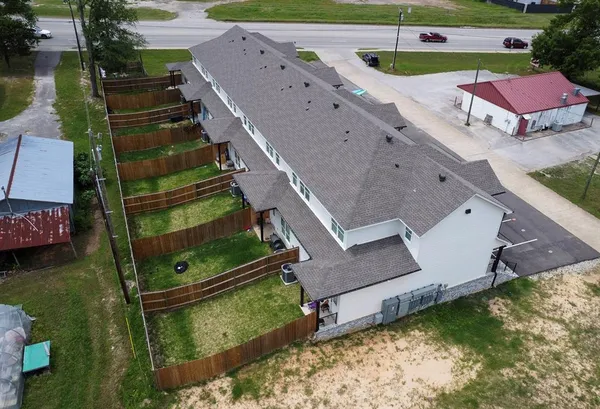 an aerial view of a house with a yard