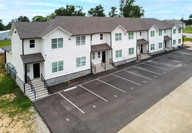 a view of a white house with a outdoor space